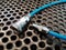 Close-up. coiled blue hose and quick coupler set on metal sheet background