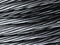 Close up of coiled metal cable industrial background