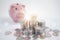 Close up of Coins stack and piggy pink on the white background, Business Finance and Money concept,Save money for prepare in the f