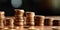 Close-up of coins stacking in ascending order, representing growth in savings or investment, concept of Diversification