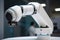 close-up of collaborative robot& x27;s arm, with its delicate fingers gripping a component