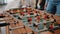 Close up of colleagues playing at foosball table after work