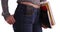 Close-up of college girl carrying books with phone in pocket on white background