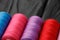 Close up of colored thread coils, thread spools background