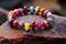 a close-up of a colorful beaded bracelet on a textured granite rock