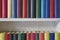 Close up of colorful books in a white shelf