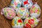 Close up of colorful decorted hand painted Easter eggs in a basket
