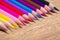 Close up of colorful drawing pencils row on wooden table