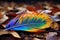 close up of a colorful feather on an autumn leaf