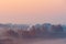 Close-up colorful foggy autumn field at sunrise. Aerial view on countryside. Colorful autumnal background. Soft focus