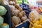 Close-up of colorful fruit stand with pears, kiwis, plums, and more