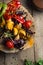 Close Up of Colorful Grilled Vegetable Bounty Tray on Wooden Pan copyspace