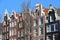 Close-up on colorful heritage buildings with gable rooftops, located along Brouwersgracht Canal in Amsterdam