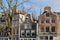 Close-up on colorful heritage buildings with gable rooftops, located along Brouwersgracht Canal in Amsterdam, Netherlands