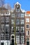 Close-up on colorful heritage buildings with gable rooftops, located along Keizersgracht canal in Amsterdam
