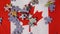 A close-up of colorful jigsaw puzzle pieces falling on the Canadian flag in slow motion. A concept by Canadian puzzle