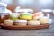 Close-up of colorful macaron macaroon on the table with hot te