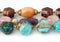 Close-up of colorful natural precious gems jewelry on white