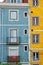 Close up of colorful old houses and windows. Lisbon, Portugal. Color blocks architecture vertical background