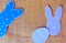 Close-up of colorful paper rabbits and paper egg silhouette frames against canvas background