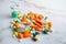 Close up of colorful pile of medicine pills on white background. Healthcare, overdose or treatment concept