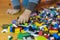 Close up of colorful plastic bricks on the floor. Early learning. Children\'s plastic constructor on the floor. Children\'s hands