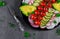 Close-up colorful raw vegetables salad and greens on wooden table