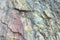 Close up of colorful rock surface, natural background, pattern and texture. Metamorphic white quartzite folded and fractured toget