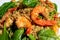 Close up colorful shrimp spinach quinoa salad on a white plate