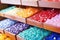 close-up of colorful soap bars stacked on a wooden shelf