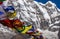 Close-up of colorful tibetan prayer flags moved by the wind and Annapurna snowcapped mountain blurred background, Himalayas