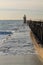 Close up on colorful wooden breakwater with lighthouse on atlantic coast, capbreton, france