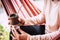 Close up coloured image with old senior hands woman caucasian drinking a natural tea from a wooden cup - natural healthy lifestyle