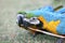 Close-up of colourful blue and gold yellow macaws playing with stick held in beaks.