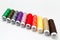 Close-up of colourful thread spools on white background. Plastic bobbins.