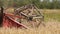close up of combine slowly drives through the field and harvests the winter wheat crop. Cultivation of grain crops in