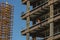 Close up of commercial office building under construction with construction workers,rebar,steel beams with weight of steel beams s