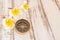 Close up compass and Tropical Plumeria flower on wooden table