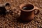 Close-up composition of a clay coffee cup with freshly brewed coffee drink with steam on the background of a bag with grains and