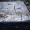 a close up of a concrete block with a crack in it