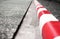 Close-up concrete sidewalks with red and white curb. Close-up No Standing and Parking line.