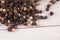 Close up of condiment on white wooden background. Bunch of different peppers on table with space for your text.