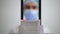 Close-up cone beam scanner with blurred unrecognizable woman in face mask at background. Dentist radiologist examining X