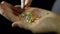 Close-up confectionery powder in a human hand on a black background.