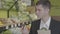 Close-up of confident adult Caucasian man choosing pomelo in grocery, putting citrus fruits into pack and leaving