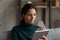 Close up confident Caucasian woman using tablet, typing on screen