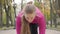 Close-up of confident young Caucasian girl at start position looking up and starting running. Attractive female runner