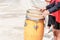 Close up of conga drums with man`s hands holding drumsticks set on concrete floor in a stadium for cheer.