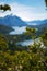 A close up on coniferous tree with the picturesque landscape of blue water lakes