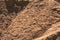 Close up of construction sand with furrows and large clumps of sand visible